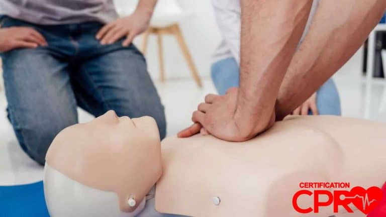 CPR training session with a man practicing on a mannequin in Tallahassee.